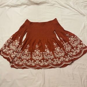 Burnt orange smocked blouse with white detail